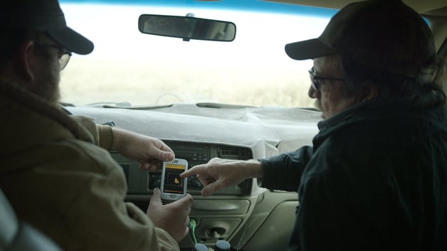 farmers in the truck looking at satellite imagery